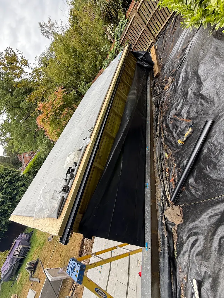 New flat roof deck and membrane over a garage, edged in fresh timber