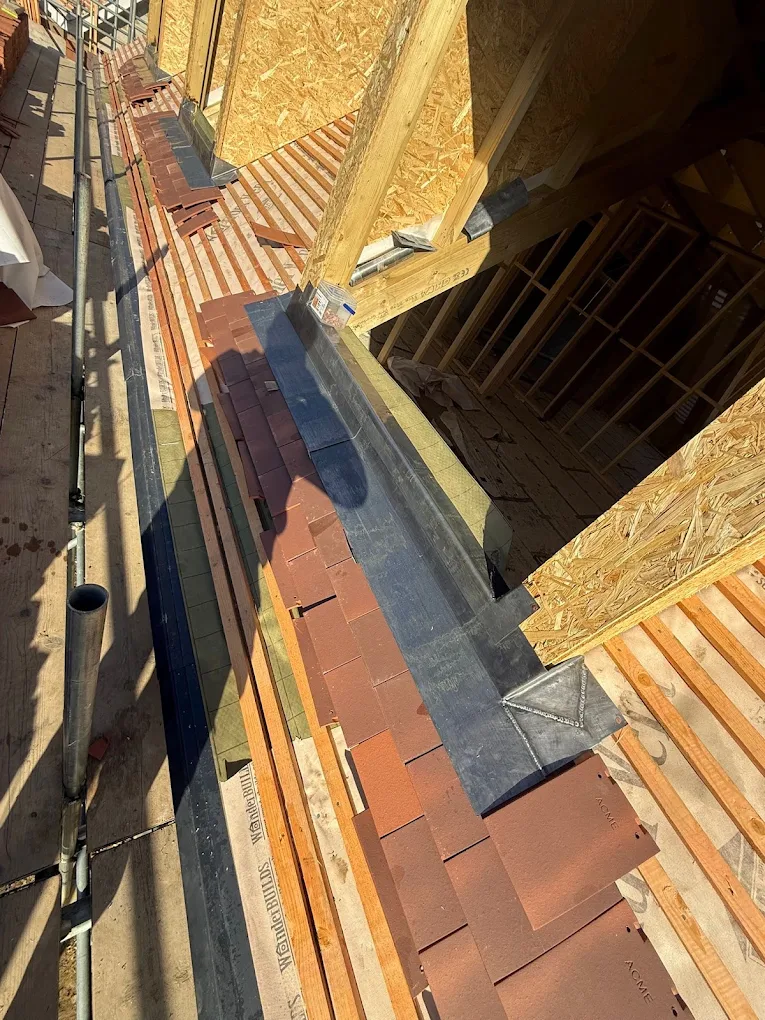 Lead valley between two tiled pitches on a new build, part way through