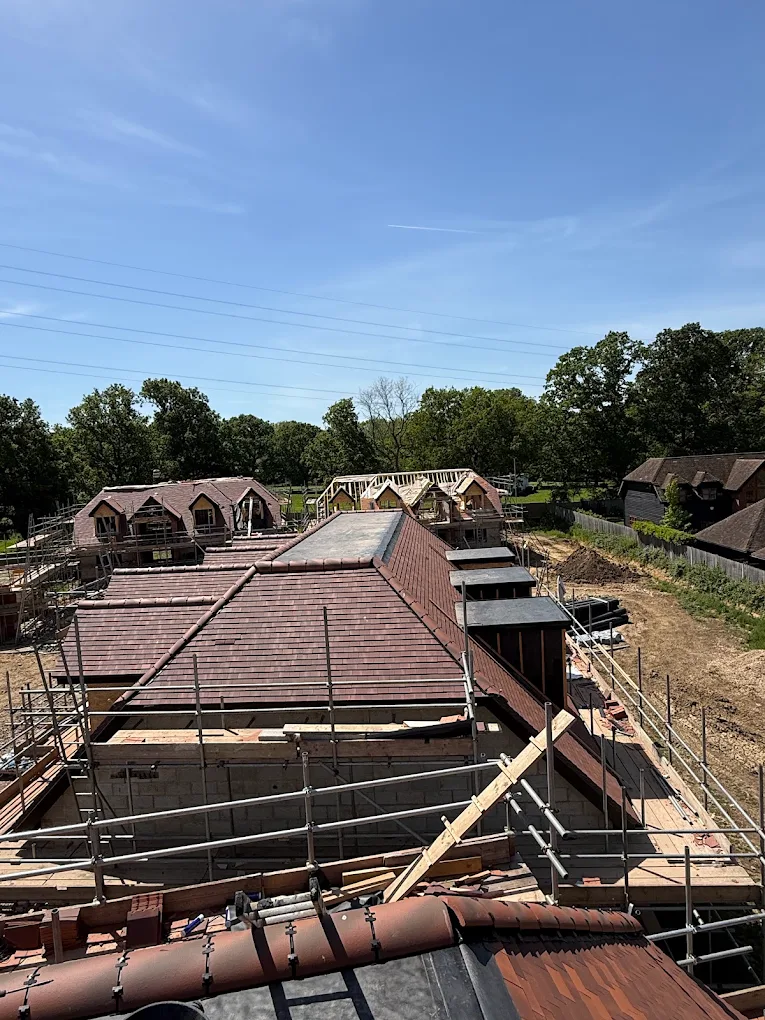 New-build housing development with scaffolded tiled roofs